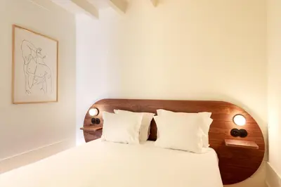 a bedroom with a white bed with two pillows at VIVA Quinta Modernista Flat in Porto
