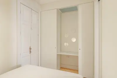 a white bedroom with a bed and a closet at VIVA Cedofeita Serviced Apartments in Porto