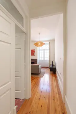 an open hallway with a living room with wood floors at VIVA Cedofeita Serviced Apartments in Porto