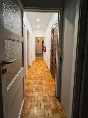 a hallway with a wooden floor and a door at Good end Oporto View in Porto
