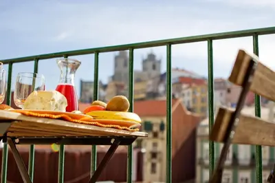 a plate of food on a table on a balcony at Porto Pacific - Rua das Flores - Flower Street in Porto