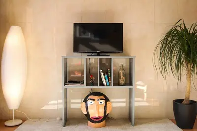 a room with a table with a tv and a head at Porto Pacific - Rua das Flores - Flower Street in Porto