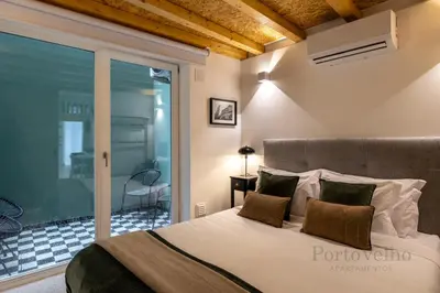 a loft bed in a living room with a staircase at Fado in Porto - Porto Velho Apt in Porto