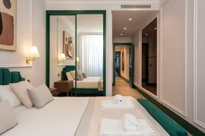 a hotel room with a bed with towels on it at Cosy Flat in Porto with Private Patio & Garden Area by Lisbeyond in Porto