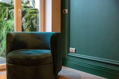 a chair sitting in a room next to a window at Cosy Flat in Porto with Private Patio & Garden Area by Lisbeyond in Porto
