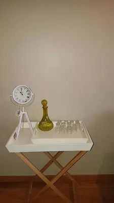 a white table with a clock on top of it at Apartamento Costa Cabral in Porto