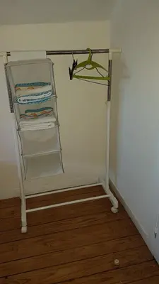 a towel rack in the corner of a room at Apartamento Costa Cabral in Porto