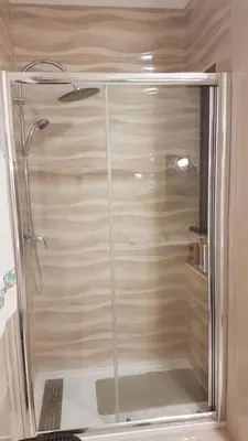 a shower with a glass door in a bathroom at Apartamento Costa Cabral in Porto