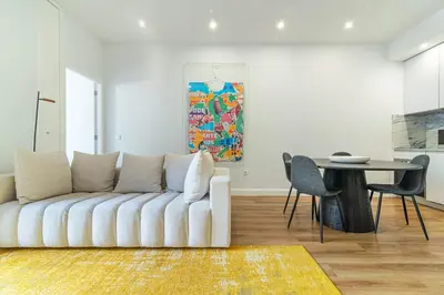 a group of chairs and an umbrella in a courtyard at Heroísmo, stylish 2 bedroom apartment in Porto