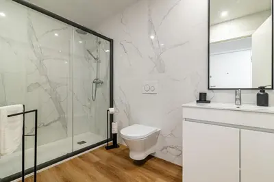 a bedroom with a large bed with towels on it at Heroísmo, stylish 2 bedroom apartment in Porto