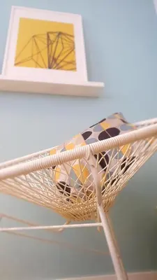 a laundry basket with a towel and a picture at T2P Pilar House in Vila Nova de Gaia
