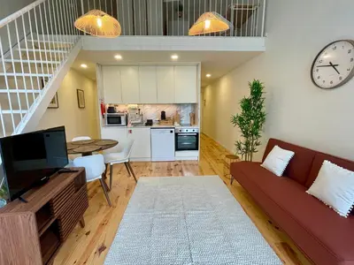 a living room with a couch and a table at Terrace Loft near Porto Center in Porto
