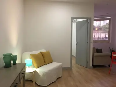 a living room with a white couch and a chair at City Center Private Parking AC in Porto