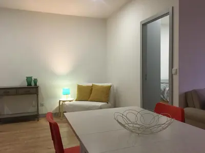 a living room with a table and a couch at City Center Private Parking AC in Porto