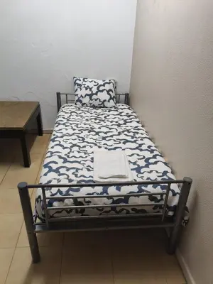 a bedroom with a bed and a table and chairs at Center Porto Economic Huge Flat in Porto