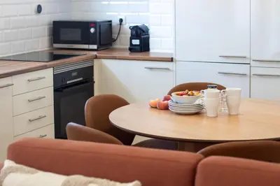 a kitchen with a table with a bowl of fruit on it at Bright 3BR Flat near Douro with AC by LovelyStay in Vila Nova de Gaia
