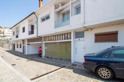 a car parked in front of a white building at Bright 3BR Flat near Douro with AC by LovelyStay in Vila Nova de Gaia