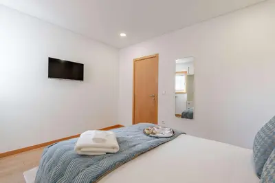 a bedroom with a bed with two towels on it at Bright & Cozy Apartment by HostWise in Vila Nova de Gaia