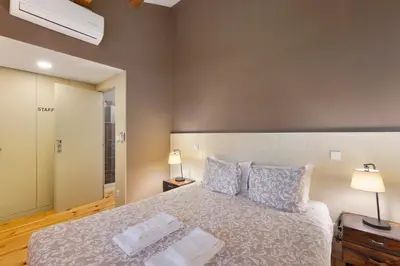 a bedroom with a large bed and a window at Orange Apartments A in Porto