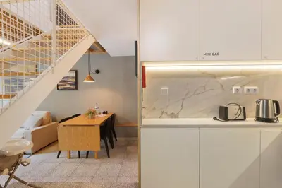 a living room with a chair and a television at Orange Apartments A in Porto