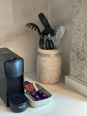 a kitchen counter with a coffee maker and a container of utensils at Casa de Duque de Loulé - Apartments by RealuptownPorto in Porto