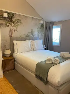 a bedroom with a large bed with towels on it at Casa de Duque de Loulé - Apartments by RealuptownPorto in Porto