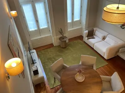 a living room with a table and a couch at Casa de Duque de Loulé - Apartments by RealuptownPorto in Porto