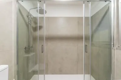 a shower with a glass door in a bathroom at Bom Sucesso Executive Suites by HostWise in Porto
