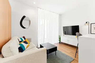 a kitchen with white cabinets and a microwave at New Luxurious, Spacious Studio With Parking in Vila Nova de Gaia