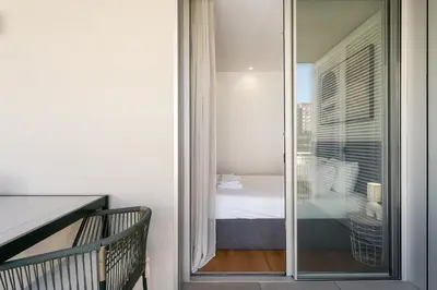 a room with a glass door leading to a bedroom at New Luxurious, Spacious Studio With Parking in Vila Nova de Gaia
