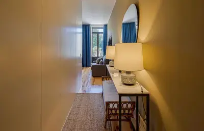 a living room with blue curtains and a table and a couch at Almada Relax in Porto