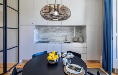 a bench under a table with two lamps on it at Almada Relax in Porto