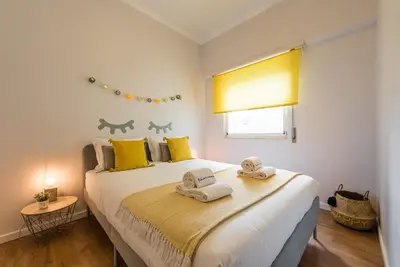a bedroom with a large bed with towels on it at GuestReady Essential - Heartbeats in Porto