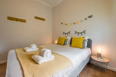 a bedroom with two beds with towels on them at GuestReady Essential - Heartbeats in Porto