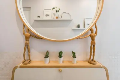 a mirror on top of a wooden shelf with potted plants at GuestReady Essential - Heartbeats in Porto