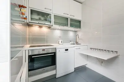 a white kitchen with a sink and a stove at GuestReady Essential - Heartbeats in Porto