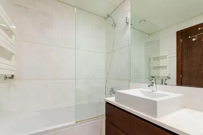 a white bathroom with a sink and a tub and a sink at Modern & Spacious Flat with Garage by HostWise in Vila Nova de Gaia