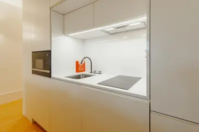 a kitchen with a sink and a microwave at Historical Taipas Apartments by Vacationy in Porto