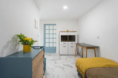 a bedroom with a bed and a desk and a table at GuestReady - Enjoy Comfort in Porto in Porto