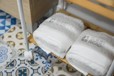 two white towels on a shelf in a room at GuestReady - Enjoy Comfort in Porto in Porto
