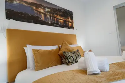 a bedroom with a bed with white sheets and pillows at Douro Garden Home Rooftop in Vila Nova de Gaia