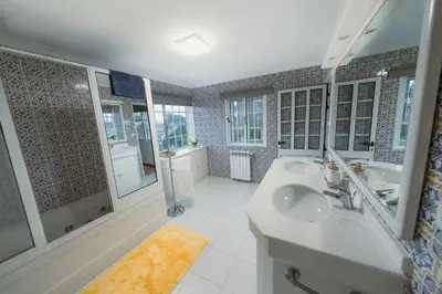 a bathroom with two sinks and two mirrors at Douro Garden Home Rooftop in Vila Nova de Gaia
