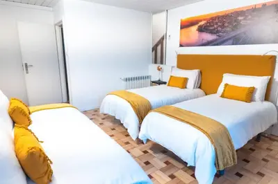 two beds in a room with white and yellow at Douro Garden Home Rooftop in Vila Nova de Gaia