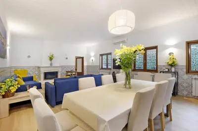 a living room with a table and a blue couch at Douro Garden House and Pool in Vila Nova de Gaia