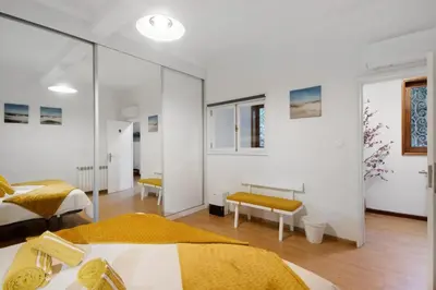 a bedroom with two beds and a glass wall at Douro Garden House and Pool in Vila Nova de Gaia