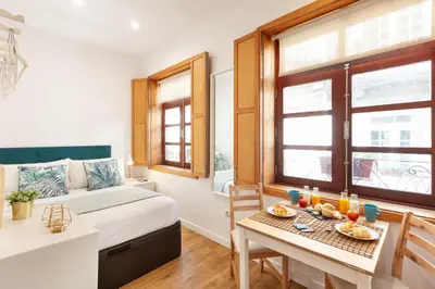 a bedroom with a bed and a table with food on it at D&S - Porto São Bento Apartments in Porto