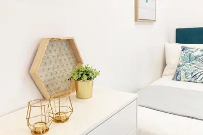 a room with a bed and a table with a plant at D&S - Porto São Bento Apartments in Porto