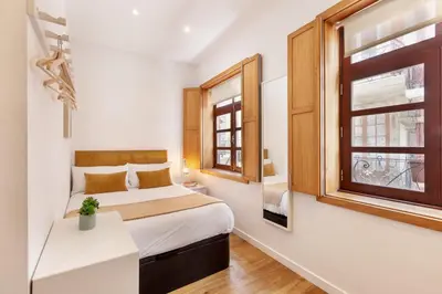 a small bedroom with a bed and a window at D&S - Porto São Bento Apartments in Porto