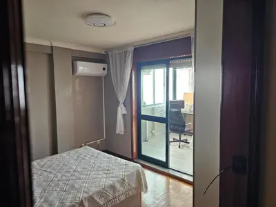 a bedroom with a bed and a window and a desk at Fabulous Antero De Quental in Porto