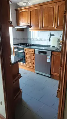 a kitchen with wooden cabinets and a stove top oven at Fabulous Antero De Quental in Porto